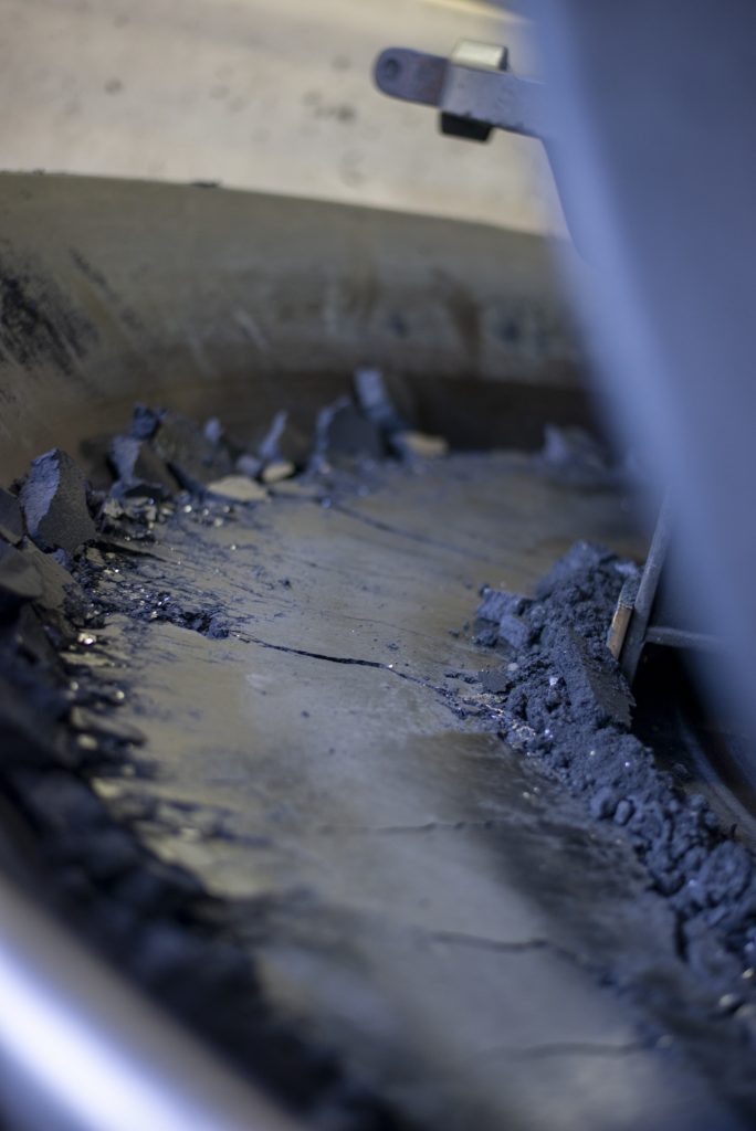 Black powder charcoal being mixed and pressed during Swiss black powder production at Poudrerie d'Aubonne